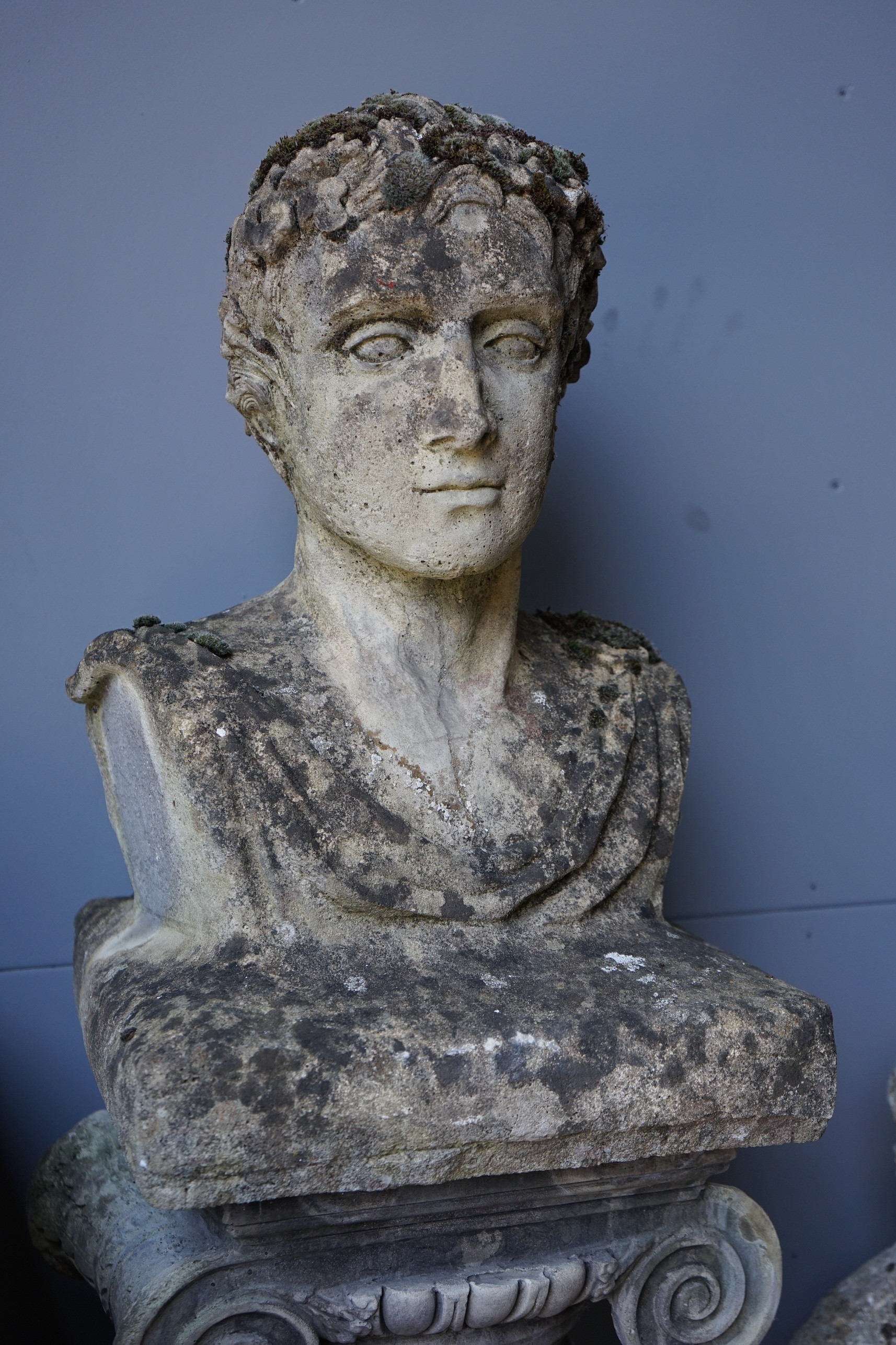A reconstituted stone bust of a Roman emperor on fluted ionic column, height 172cm